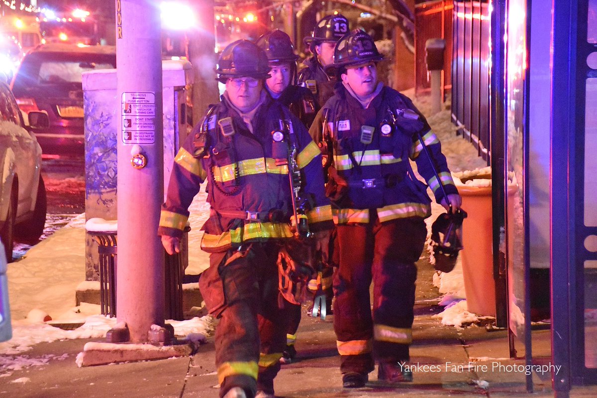 Rochester firefighters operating at a working fire in a high-rise apartment building on East Main Street