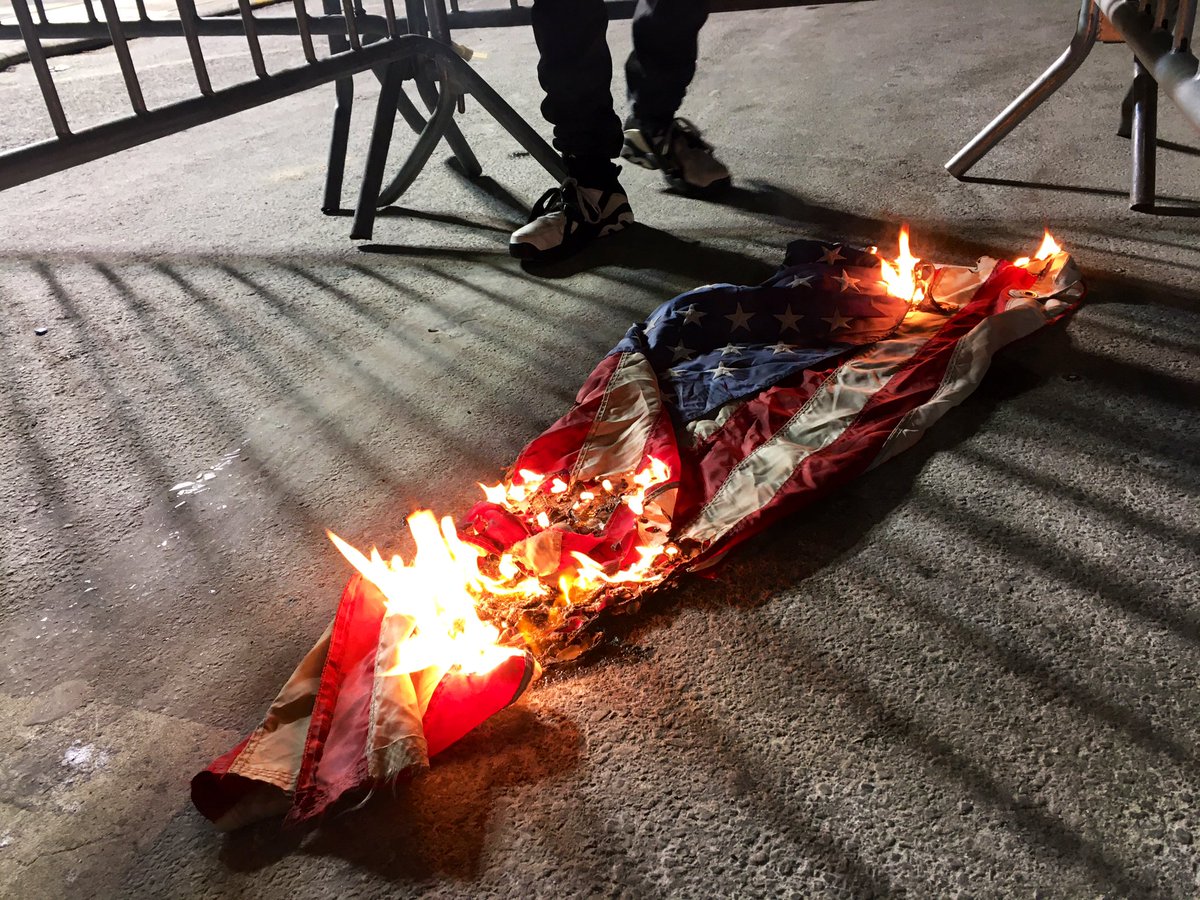 Protesters in the Bronx marched to NYPD's 46th precinct last night to demand justice for MikeRosado & freedom for his dad Rafael, who is currently locked up for shooting back at the policemen who killed his son. A USA flag was burned & protesters did some radical artwork