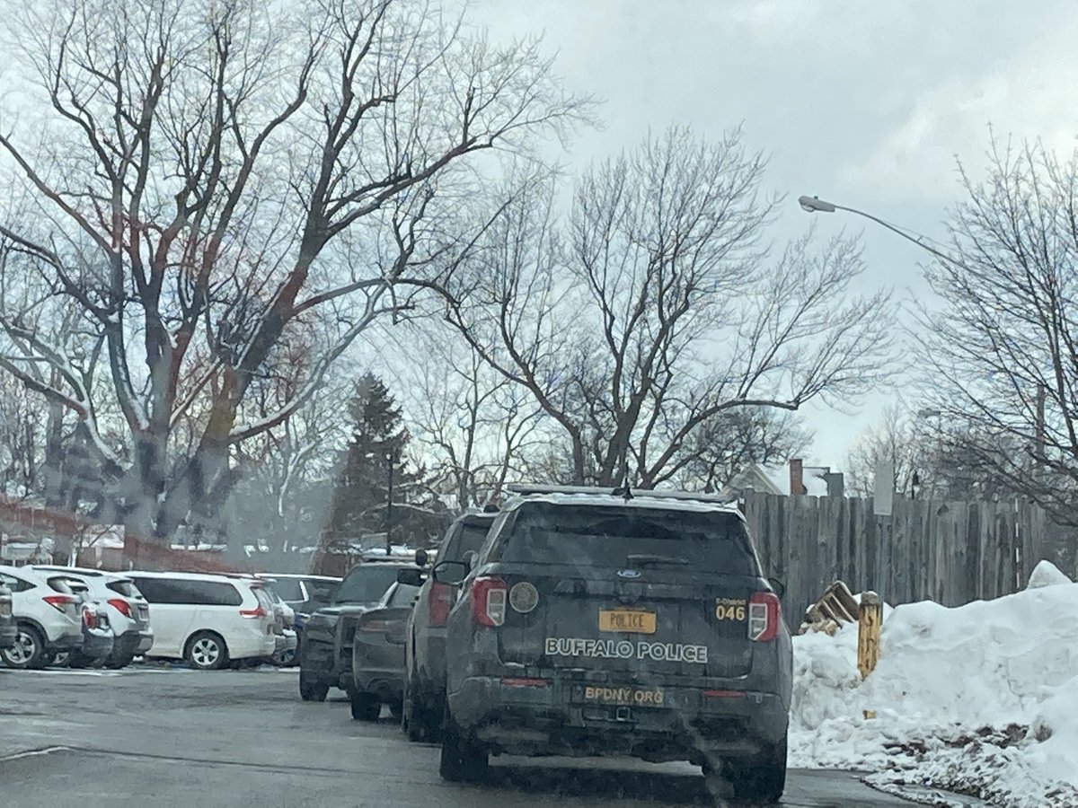 Several Buffalo police officers and vehicles on the scene at Bennett High School