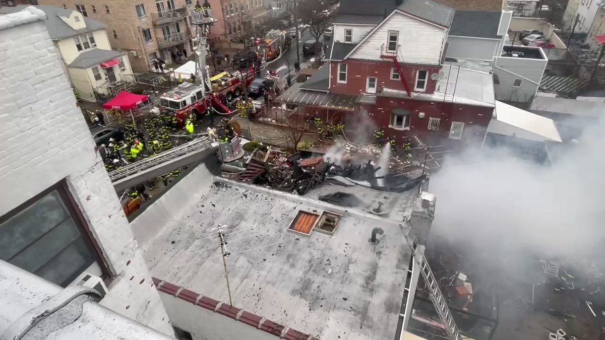 View from neighboring apartment building in Bath Beach as firefighters continue to put out hotspots after a home exploded this morning. Neighbor said they smelled gas. 