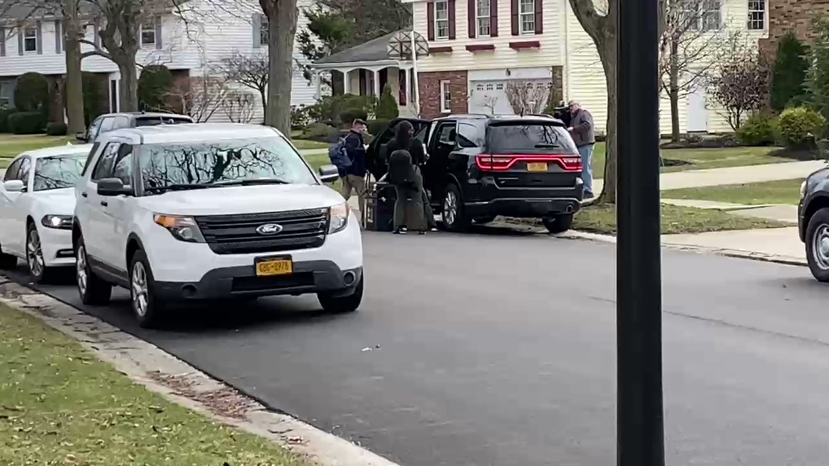 Law enforcement bring materials out of the home of Judge John Michalski