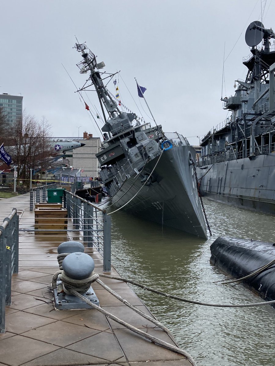 This gives a better perspective of the list angle of USS The Sullivan's. Salvage crews trying to figure out some way to pump water but difficult situation to right this ship. Very thin hull may have been punctured near stern (back) of ship