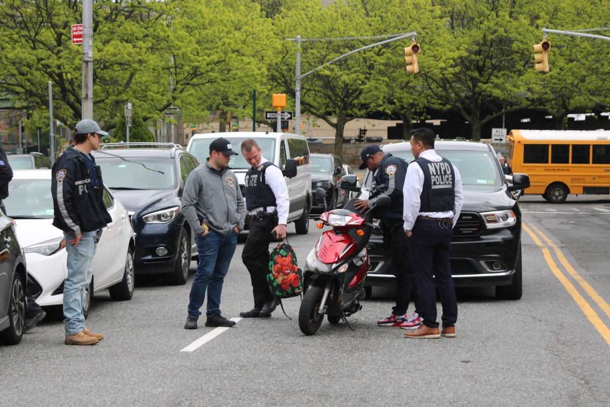 Detectives secure the scooter that was used in the shooting of a MOS son near Maspeth HS. Detectives were able to take 2 rioters into custody near Queens Center Mall