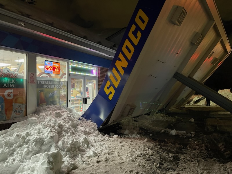 Snow tips over Sunoco sign outside Buffalo