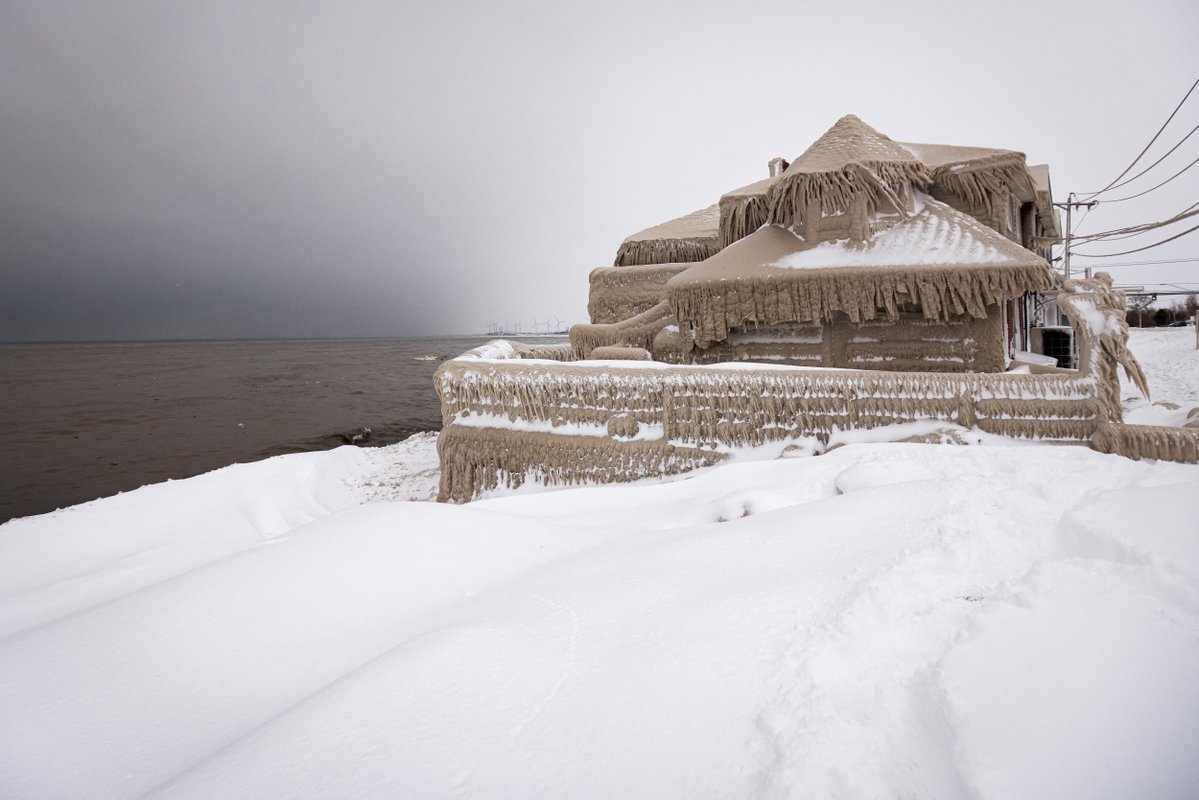 Millions of Americans have endured a winter storm that forecasters said was nearly unprecedented in its scope. These pictures show the ice that formed over a restaurant in Hamberg, New York from the spray of Lake Erie waves 