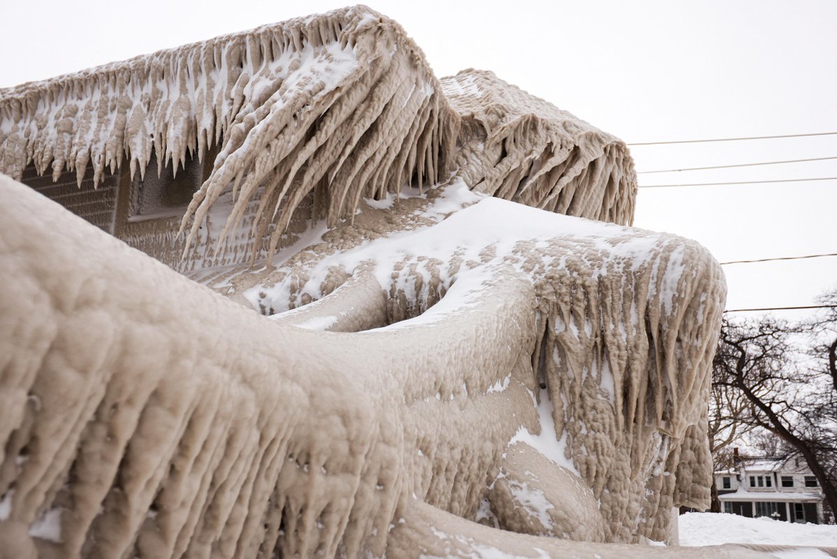 Millions of Americans have endured a winter storm that forecasters said was nearly unprecedented in its scope. These pictures show the ice that formed over a restaurant in Hamberg, New York from the spray of Lake Erie waves 