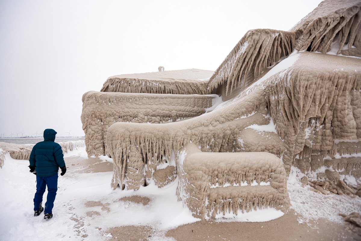 Millions of Americans have endured a winter storm that forecasters said was nearly unprecedented in its scope. These pictures show the ice that formed over a restaurant in Hamberg, New York from the spray of Lake Erie waves 