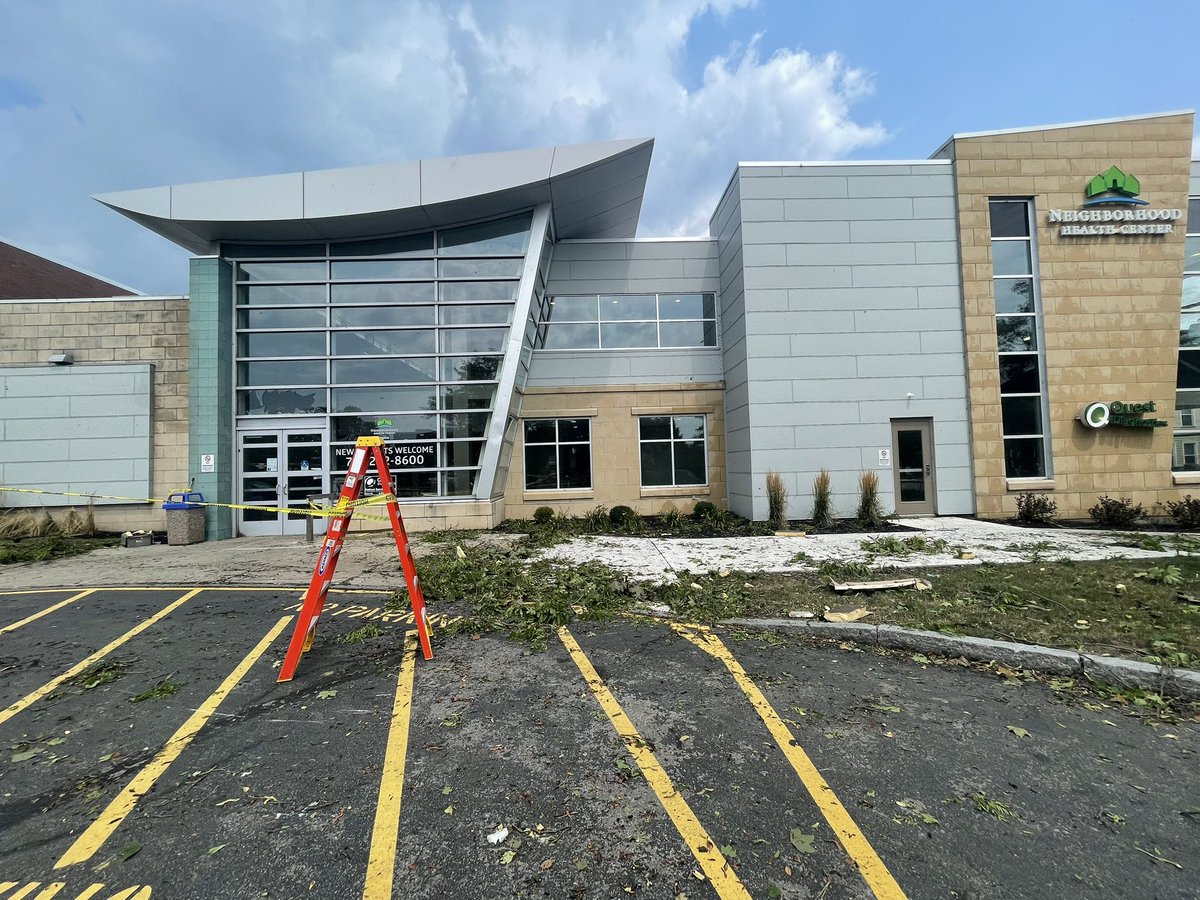 Amongst some of the wreckage you can see, what appears to be, some pieces of roofing and insulation from nearby buildings. The Neighborhood Health Center has a good amount of damage in the parking lot, and also a window pane broken at their entrance