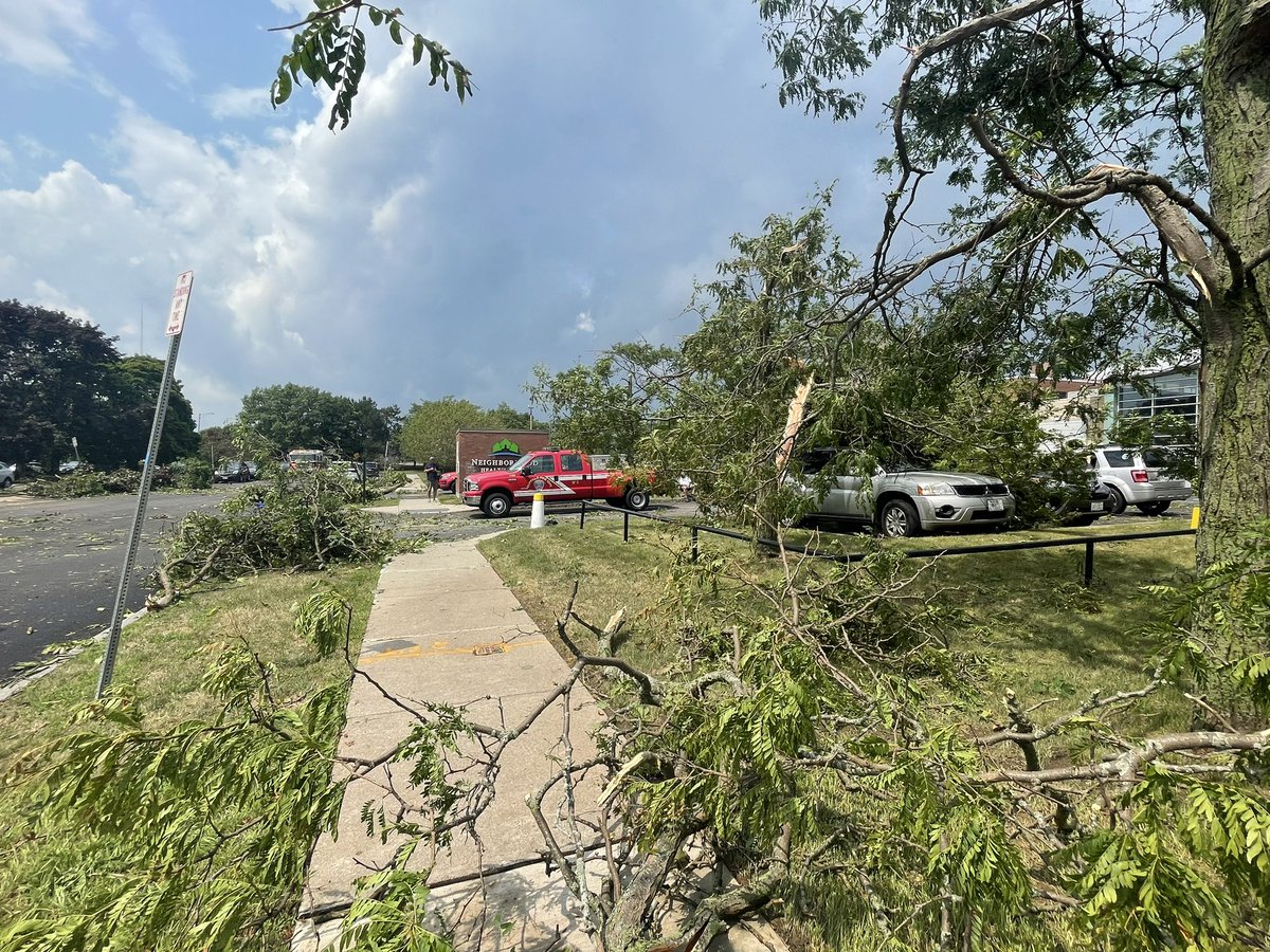 Amongst some of the wreckage you can see, what appears to be, some pieces of roofing and insulation from nearby buildings. The Neighborhood Health Center has a good amount of damage in the parking lot, and also a window pane broken at their entrance