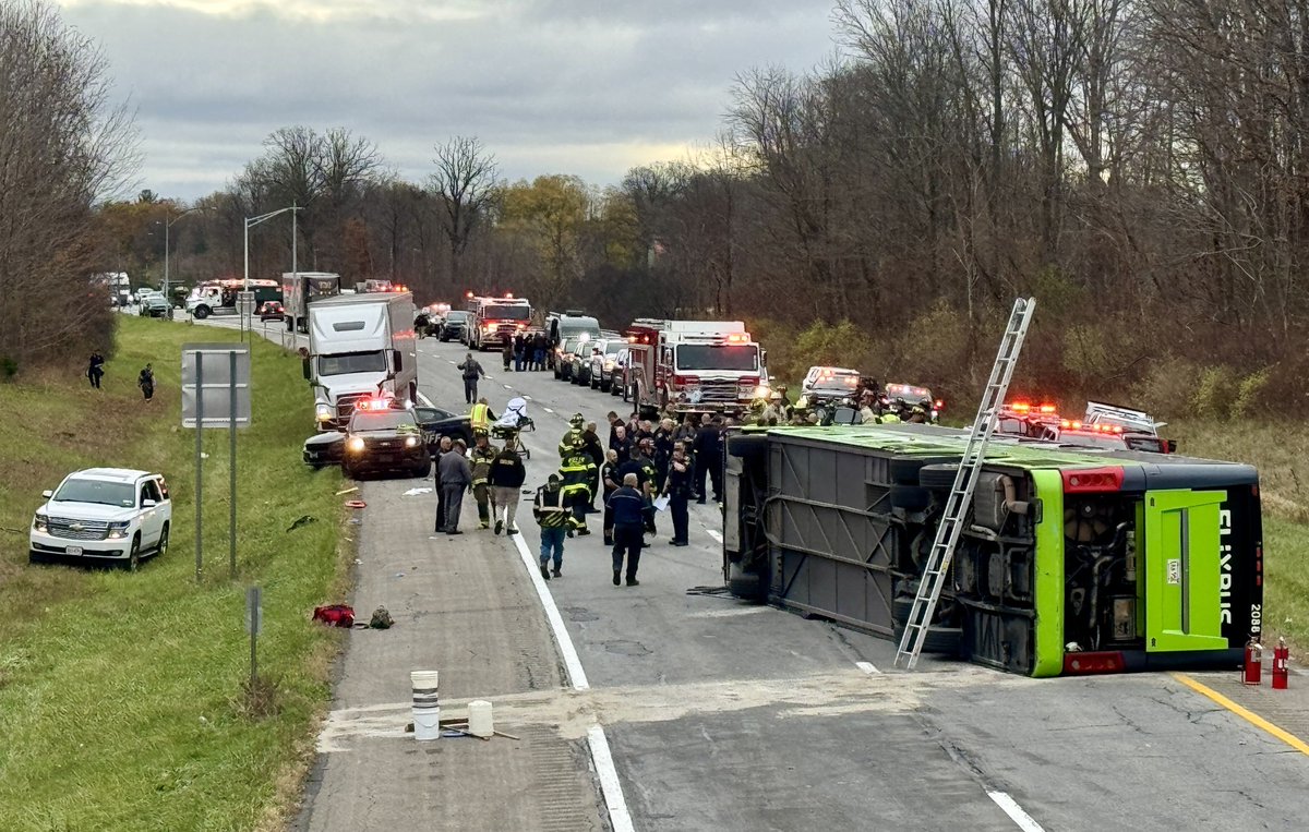 Multiple people were hospitalized — one in critical condition — after a tour bus flipped on Thursday morning