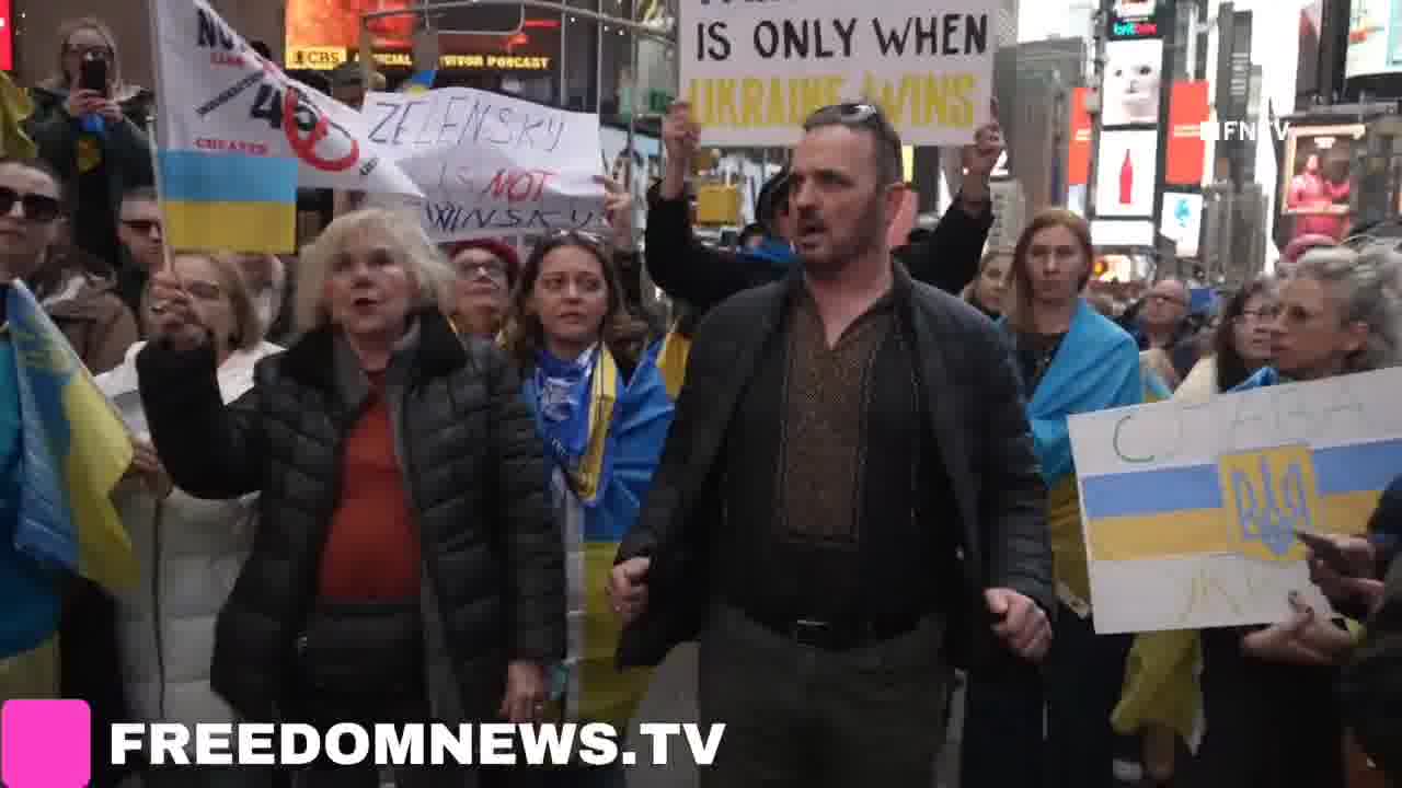 Ukrainians sing American national anthem as they gather in Times Square in Emergency protest