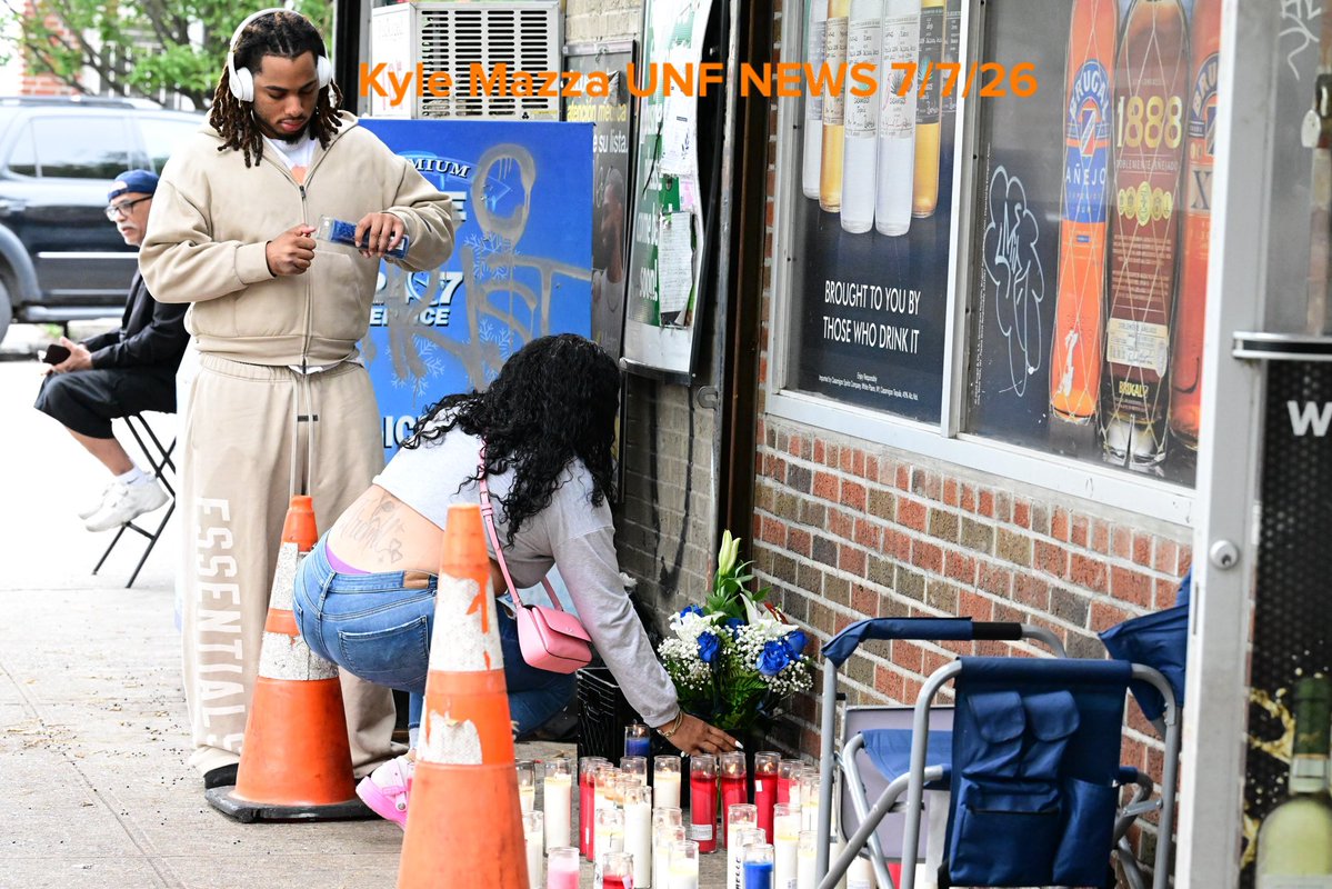 NYPD detectives and NYPD officers canvass the scene and search for clues as mourners place candles and add to a growing memorial in memory of 46-year-old Shaun Whitchett who was fatally shot to the head in the area of White Plains Road and Archer Street in Bronx