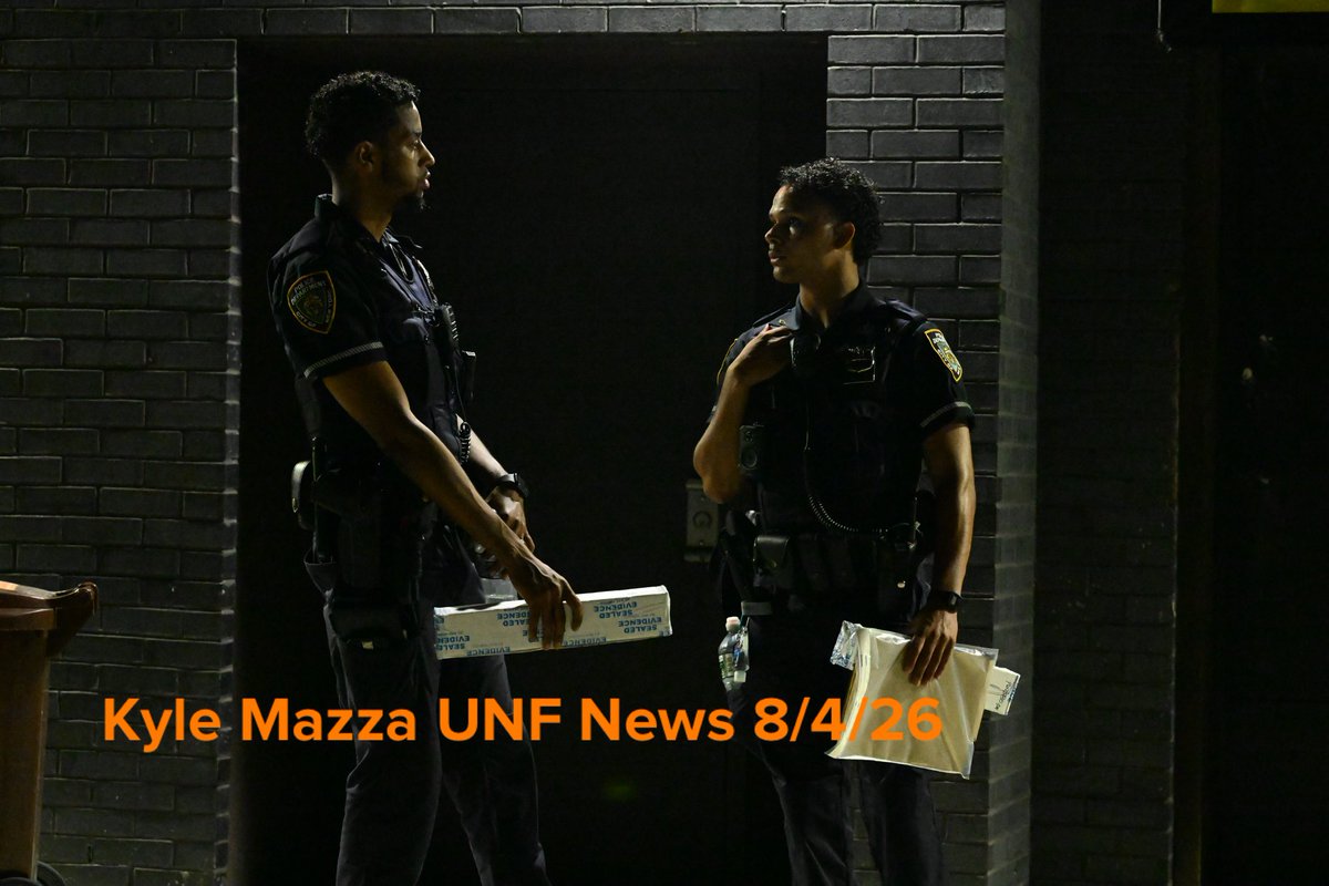 NYPD officers hold evidence boxes containing scissors and other evidence after a 33-year-old man was stabbed inside of a building at 1353 Purdy Street within the confines of the 43 precinct in Bronx, New York