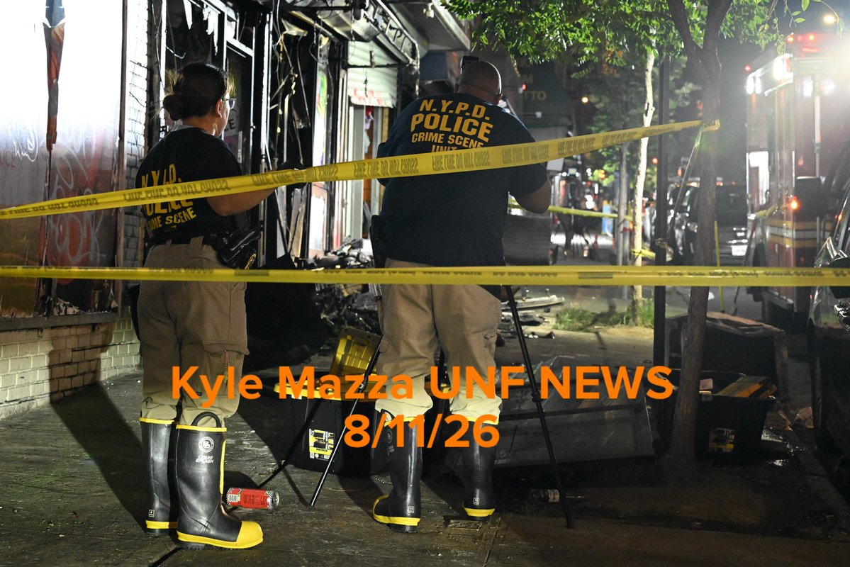 Members of the NYPD Crime Scene Unit work the scene of a fire that damaged several businesses in the area of West 183 Street within the confines of the 52 precinct in Bronx, New York