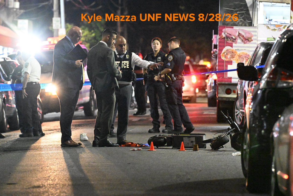 NYPD officers work the scene where a 13-year-old boy and an 18-year-old man were shot in the area of 39th Avenue and 104th Street in Queens, New York, United States on Friday