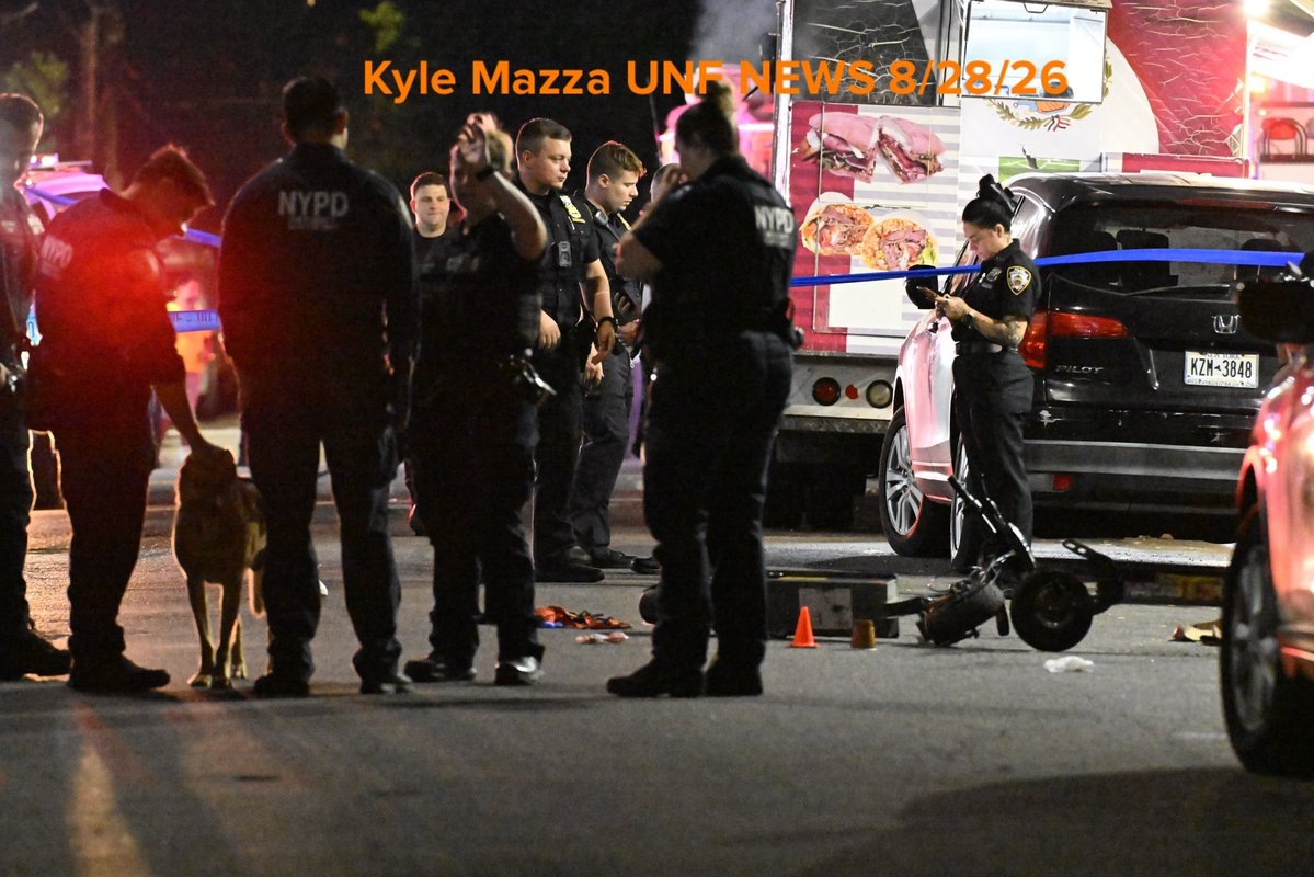 NYPD officers work the scene where a 13-year-old boy and an 18-year-old man were shot in the area of 39th Avenue and 104th Street in Queens, New York, United States on Friday