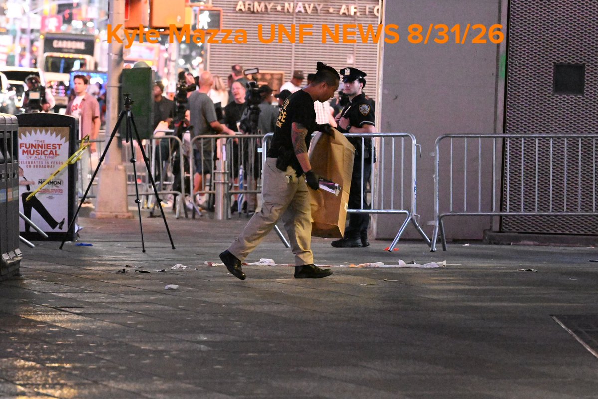 Crime scene unit investigators collect evidence including blood and shell casings at the scene after NYPD officers shot and killed a knife-wielding woman who fatally stabbed a woman and injured a man in Times Square near the area of West 42nd Street and 7th Avenue  