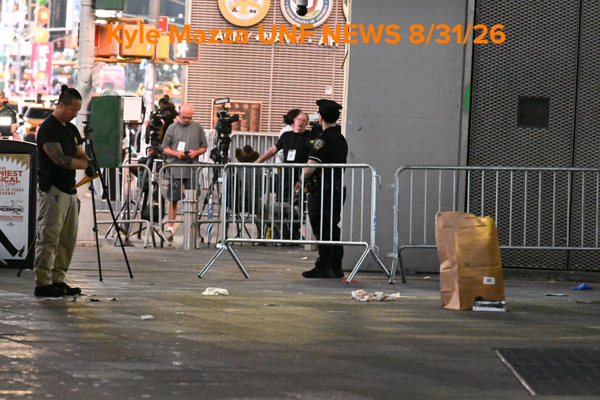Crime scene unit investigators collect evidence including blood and shell casings at the scene after NYPD officers shot and killed a knife-wielding woman who fatally stabbed a woman and injured a man in Times Square near the area of West 42nd Street and 7th Avenue  