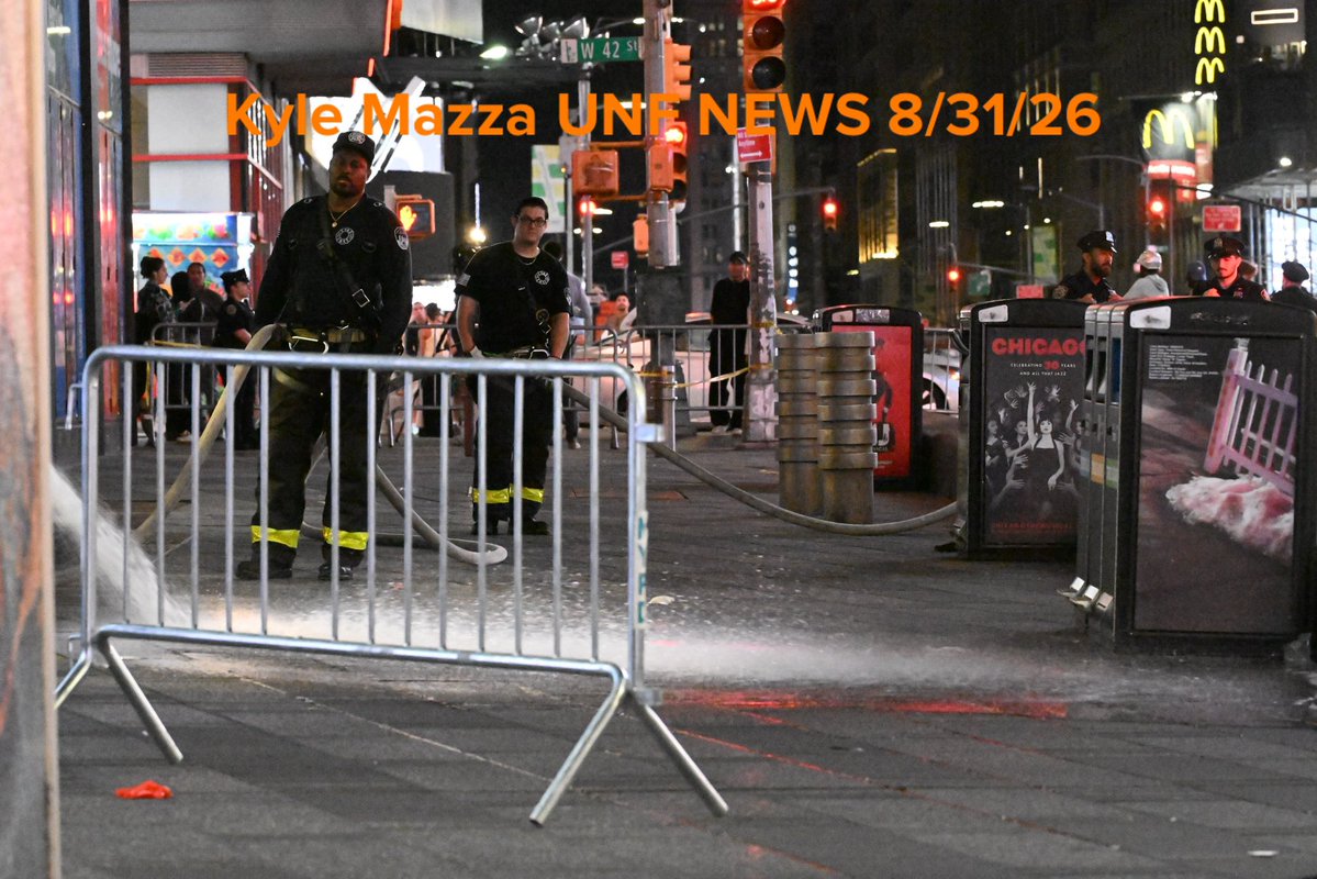 FDNY firefighters wash down the scene after NYPD officers shot and killed a knife-wielding woman who fatally stabbed a woman and injured a man in Times Square near the area of West 42nd Street and 7th Avenue in Times Square, Manhattan 