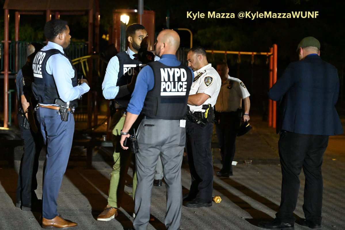 NYPD detectives and officers work at the scene where two men were fatally shot in the vicinity of Howard Playground at Mother Gaston Boulevard and Glenmore Avenue within the confines of the 73 precinct in Brooklyn, New York, United States on Friday 